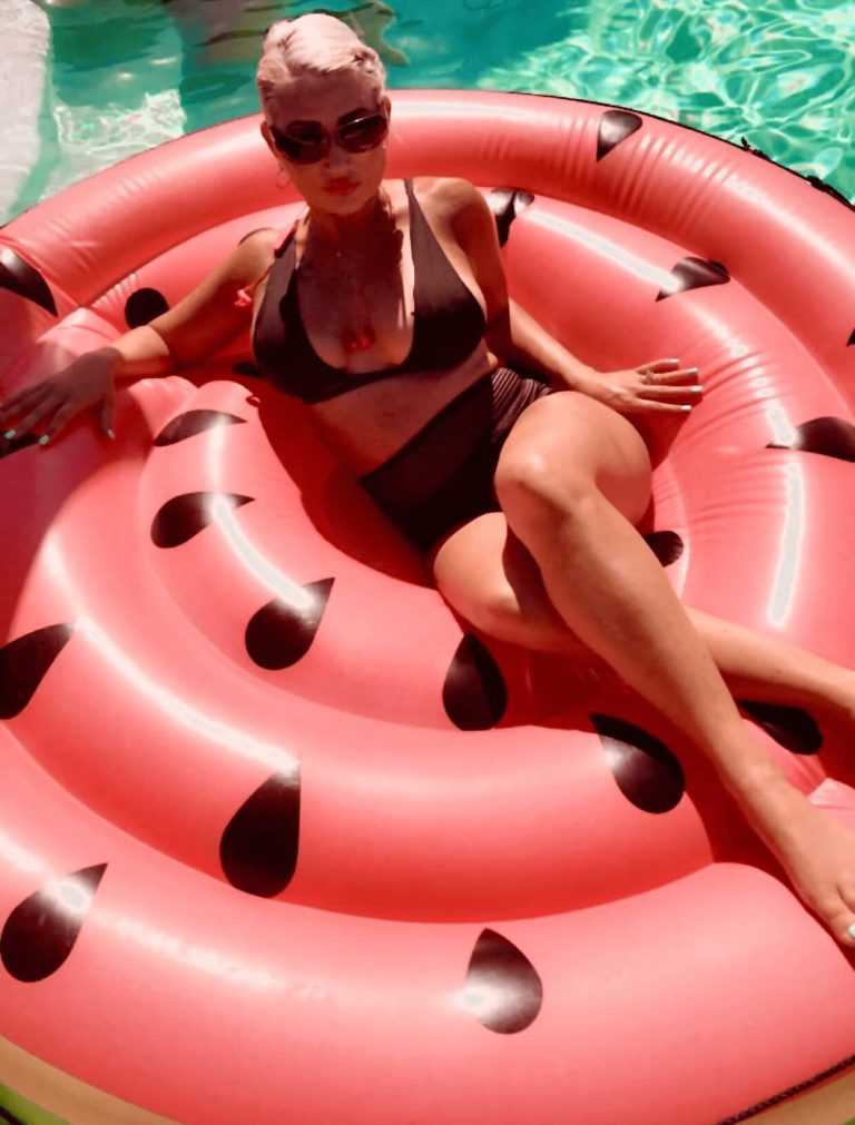 woman lounging on inflatable floatie in pool