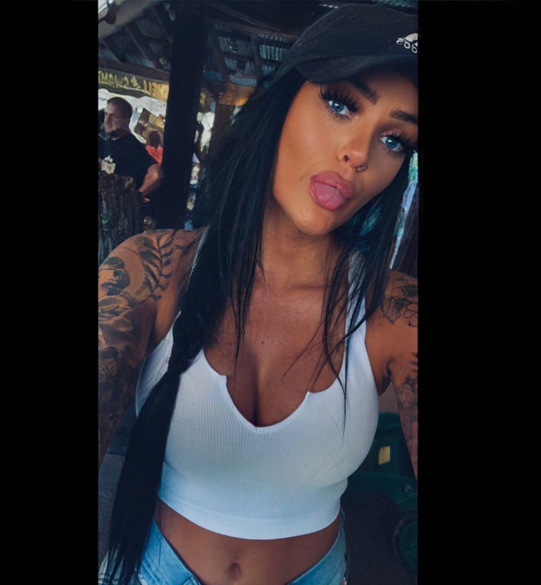 woman in black hat and white tank top
