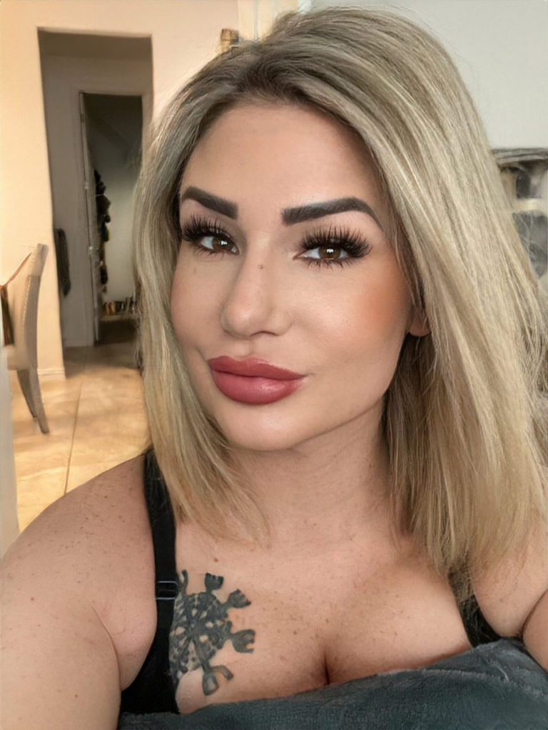 woman with tattoo posing for selfie