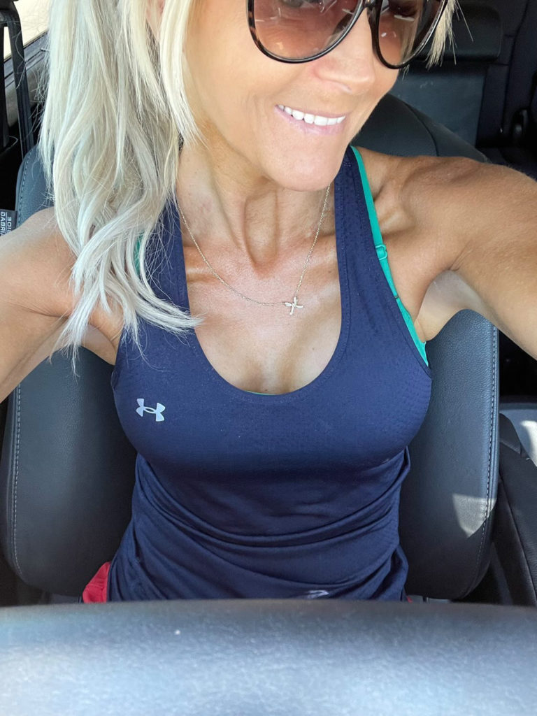 close up of woman in sunglasses posing in car