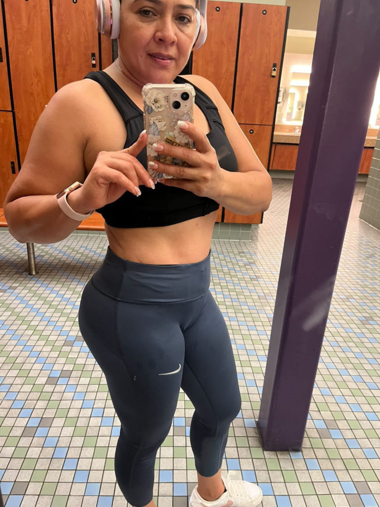 close up of woman standing in front of gym mirror