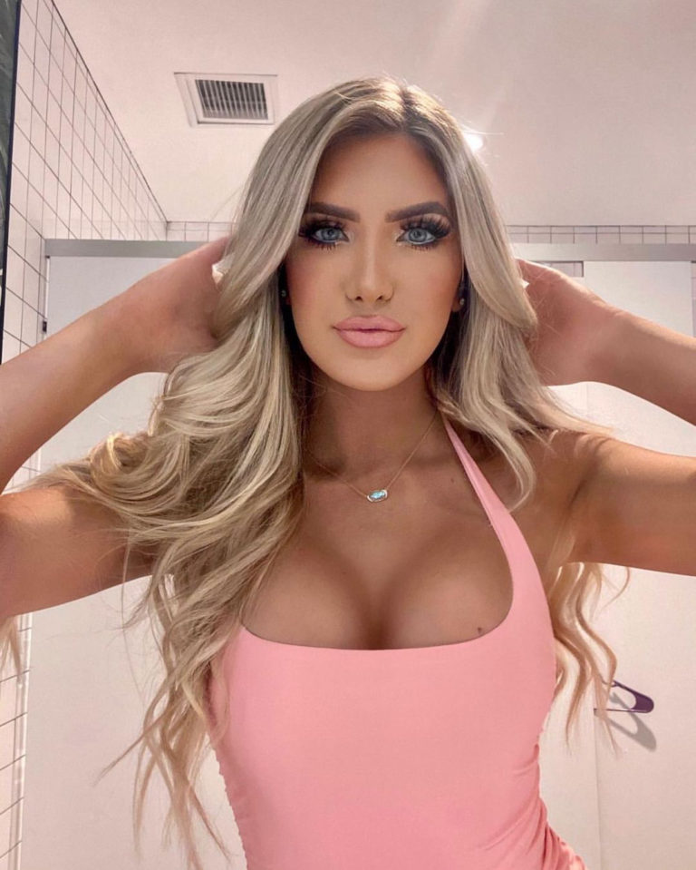 woman in light pink top posing