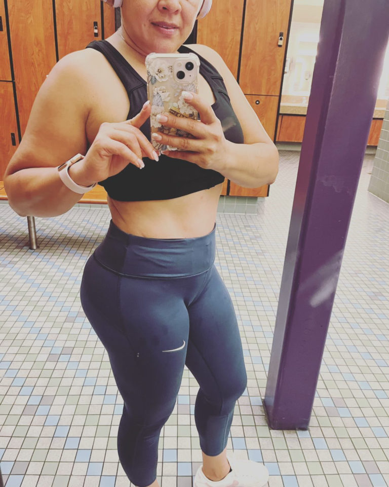 woman in leggings posing in close up mirror selfie