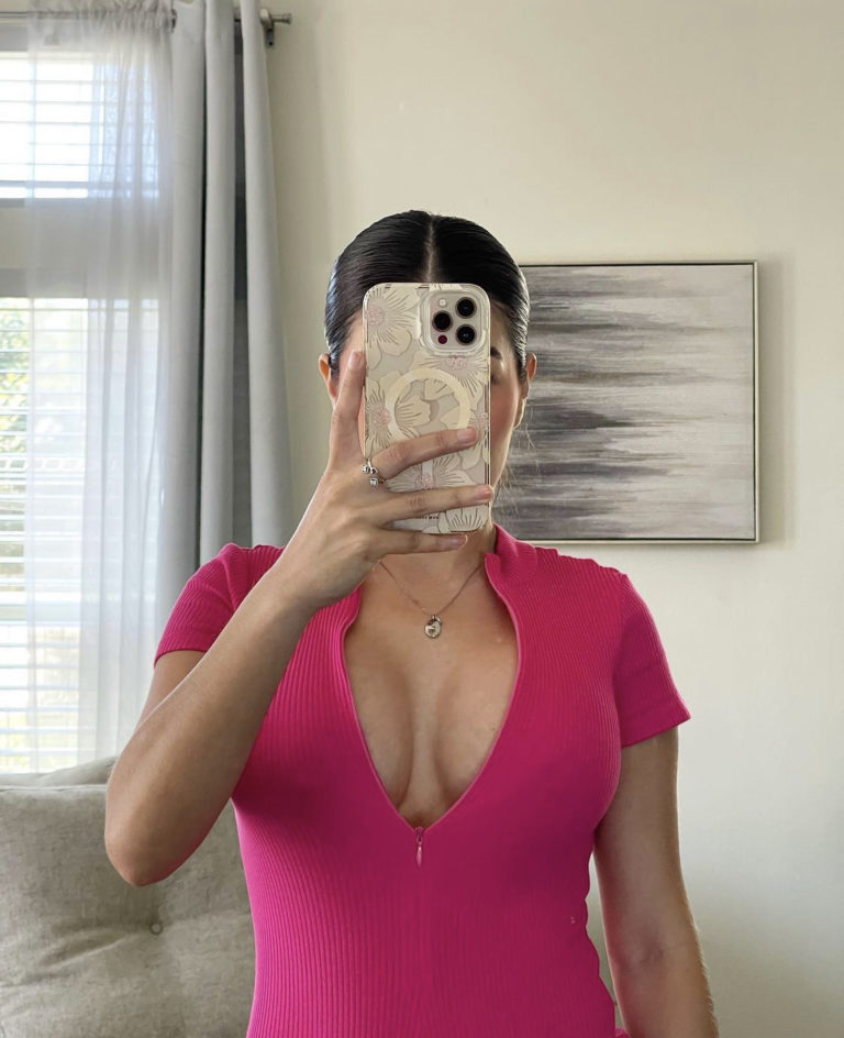 close up mirror selfie of woman in pink outfit